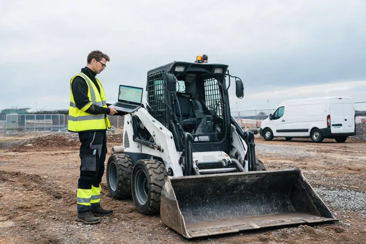 Dealer technician servicing Bobcat loader